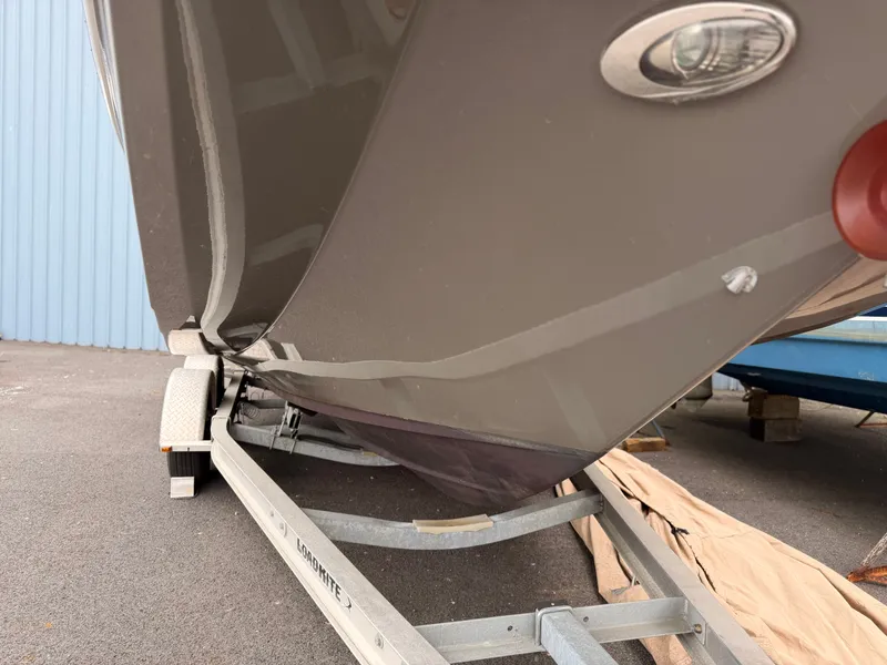 Slide: The Image of 2013 Regal 24 FasDeck boat on trailer, close-up of hull. - 11