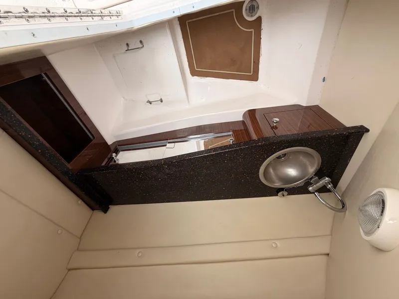 Slide: The Image of Interior of 2013 Regal 24 FasDeck with sink and storage. - 13