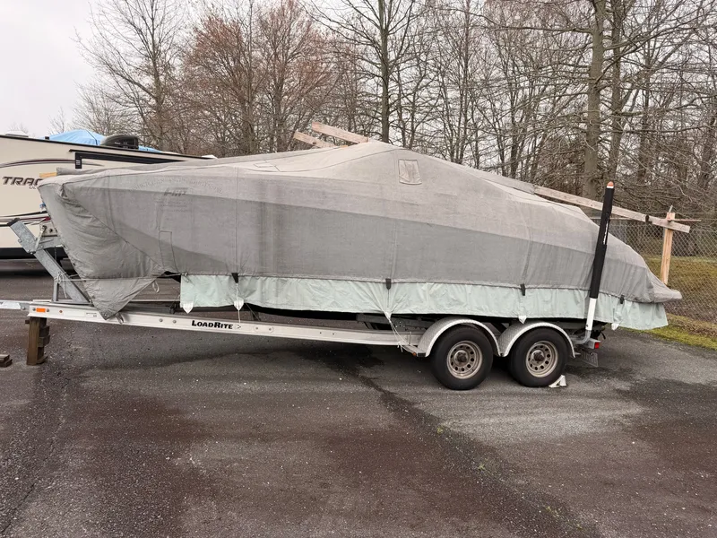 Slide: The Image of 2013 Regal 24 FasDeck boat covered on trailer. - 19