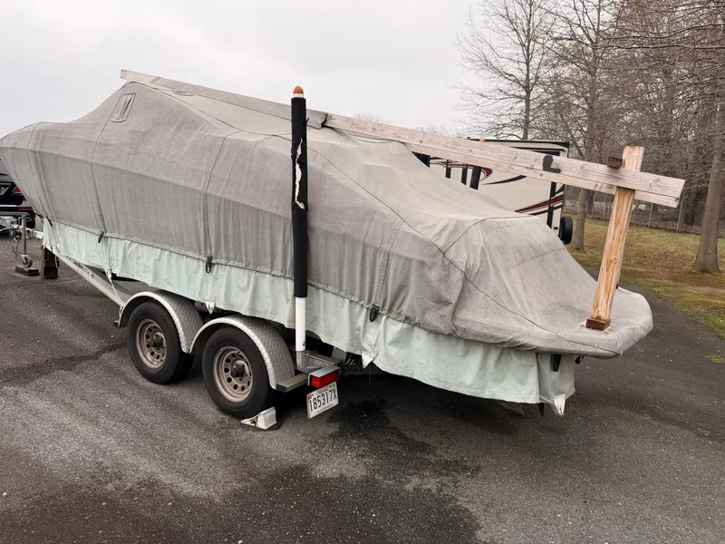 Slide: The Image of 2013 Regal 24 FasDeck boat covered on trailer. - 21