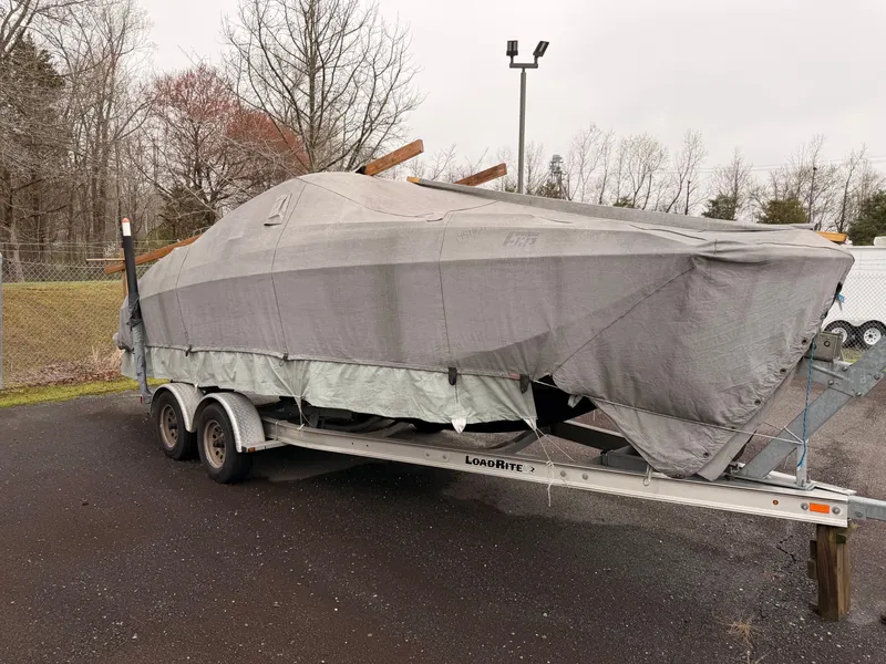 Slide: The Image of 2013 Regal 24 FasDeck boat on trailer, covered. - 22