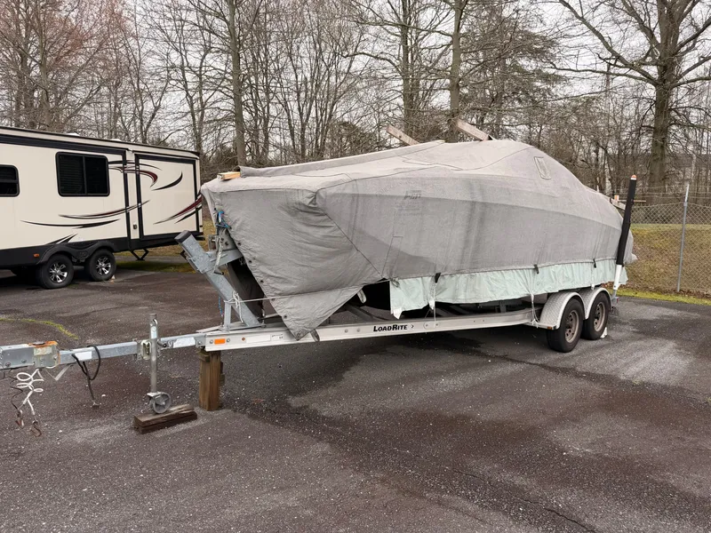 Slide: The Image of Covered 2013 Regal 24 FasDeck boat parked on trailer. - 23