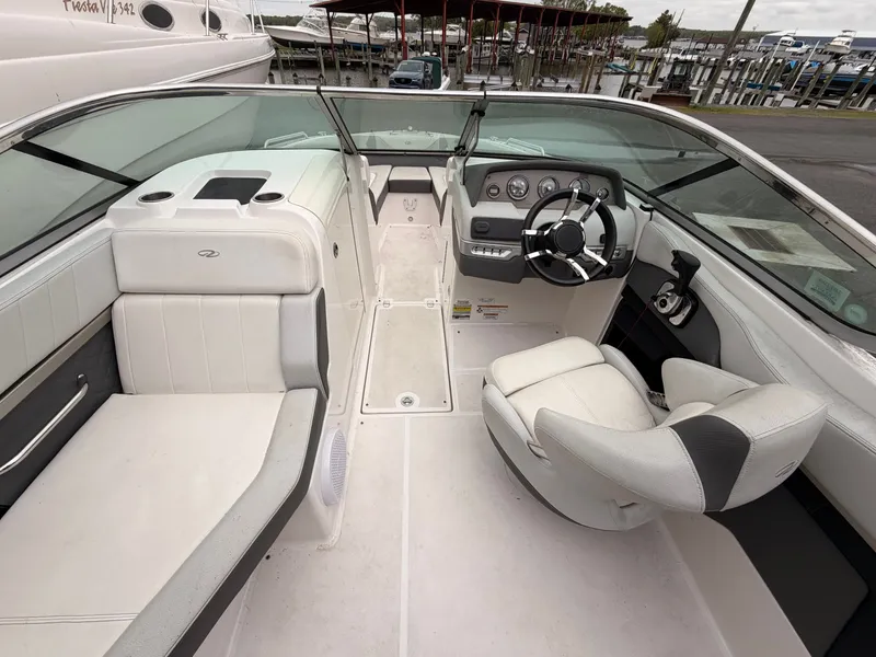 Slide: The Image of Interior of a 2013 Regal 24 FasDeck boat, white upholstery, helm station visible. - 7