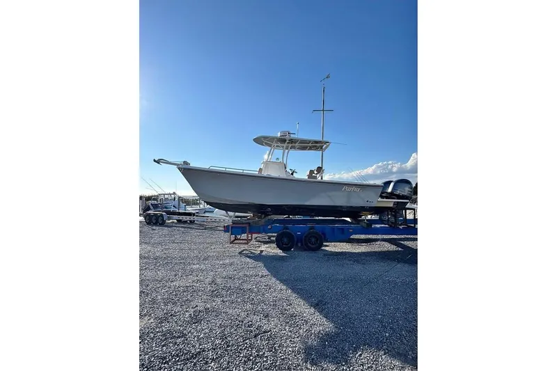 The Image of 2019 Parker 2501 Center Console boat on trailer under clear blue sky. - 0