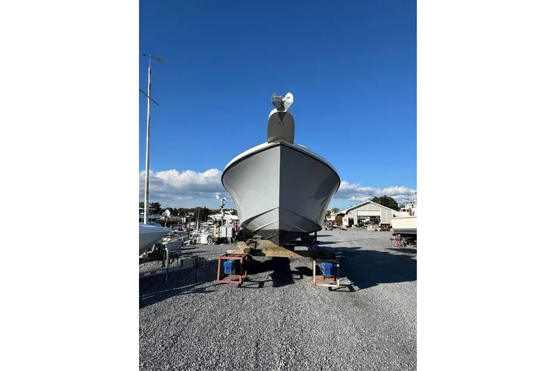 Slide: The Image of 2019 Parker 2501 Center Console boat on dry dock under clear blue sky. - 12