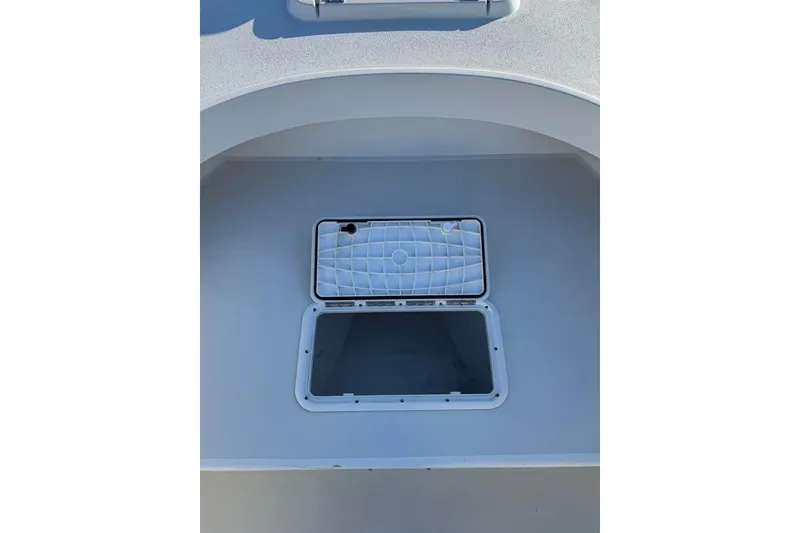 Slide: The Image of Open storage compartment on a 2019 Parker 2501 Center Console boat. - 14