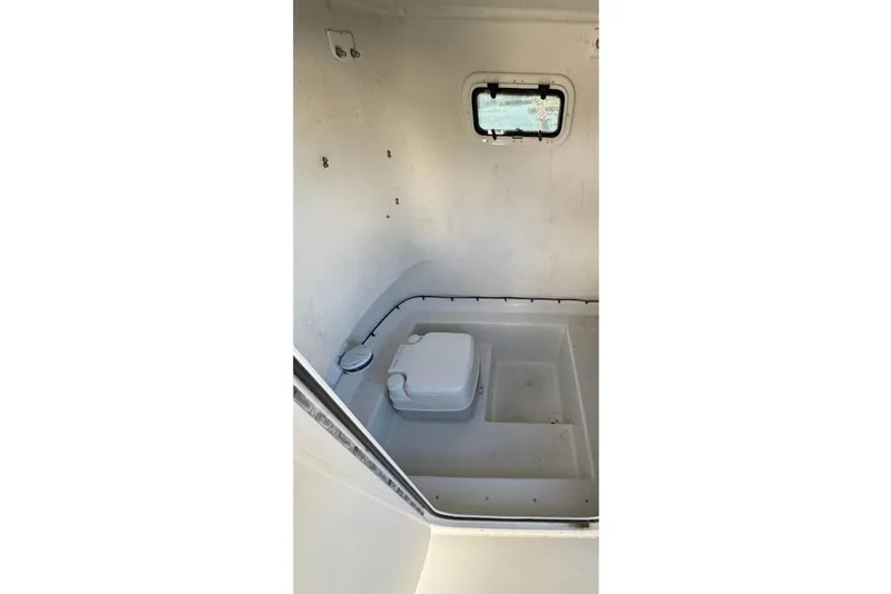 Slide: The Image of Interior of 2019 Parker 2501 Center Console boat with compact marine toilet. - 15