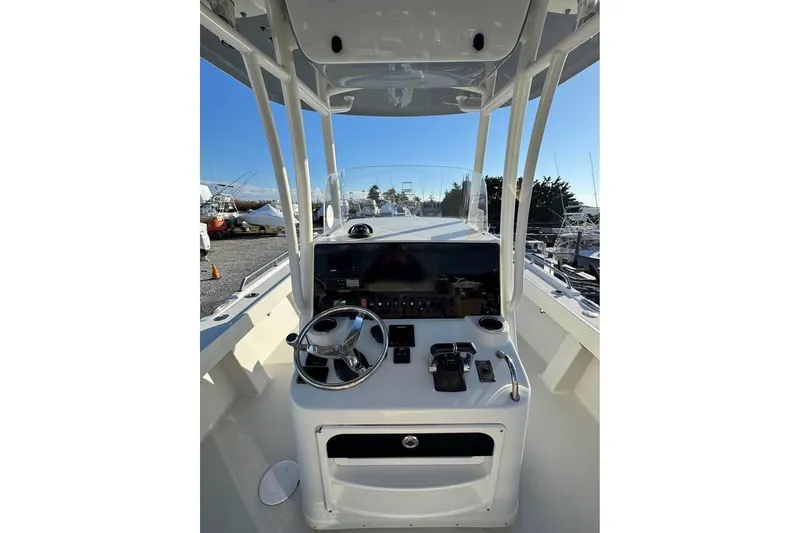 Slide: The Image of 2019 Parker 2501 Center Console boat dashboard with steering wheel and controls. - 4