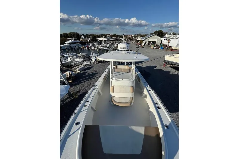 Slide: The Image of 2019 Parker 2501 Center Console boat in a marina, clear sky background. - 5