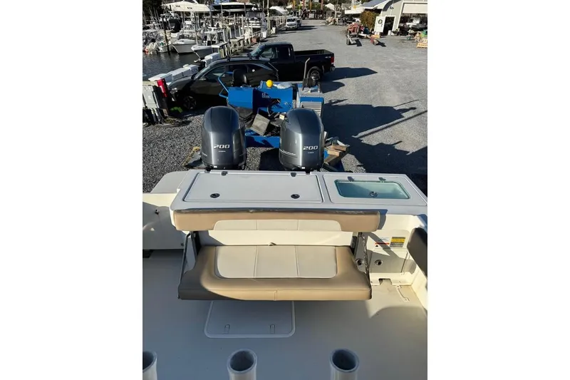 Slide: The Image of 2019 Parker 2501 Center Console boat with dual 200 horsepower engines at a marina. - 6