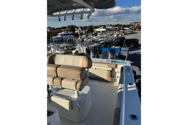 Slide: The Image of 2019 Parker 2501 Center Console boat at marina with dual engines. - 7