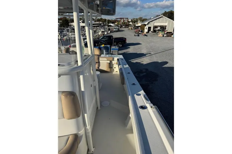 Slide: The Image of 2019 Parker 2501 Center Console boat docked at a marina under a clear sky. - 8