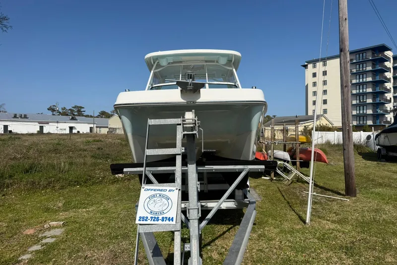 Slide: The Image of 2023 World Cat 230 DC boat on trailer at marina, sunny day. - 11