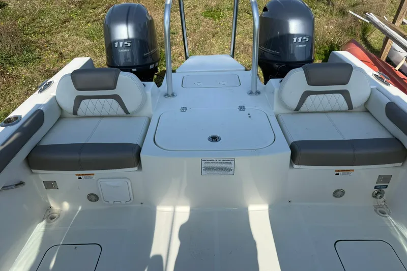 Slide: The Image of 2023 World Cat 230 DC boat interior with dual Yamaha 115 engines. - 13