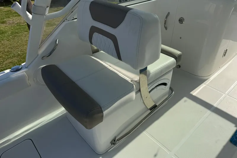 Slide: The Image of 2023 World Cat 230 DC boat seat with white and gray upholstery. - 14