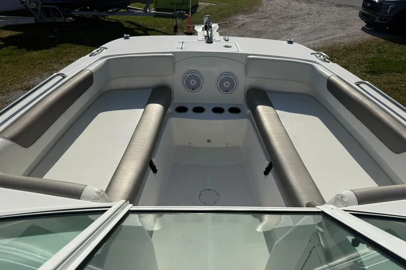 Slide: The Image of 2023 World Cat 230 DC boat interior with cushioned seating and cup holders. - 15