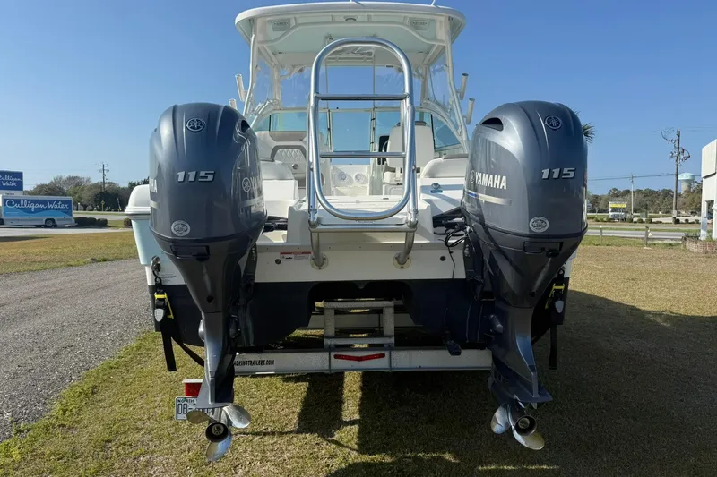 Slide: The Image of 2023 World Cat 230 DC boat with dual Yamaha 115 engines, rear view. - 19