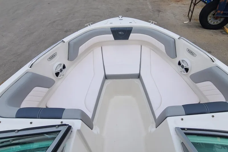 Slide: The Image of 2020 Chaparral 21 SSi OB boat interior with cushioned seating and speakers. - 11