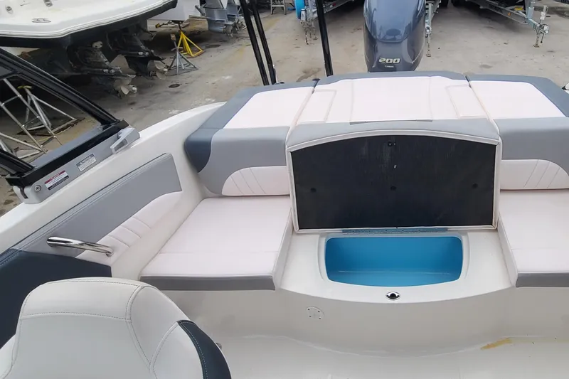 Slide: The Image of 2020 Chaparral 21 SSi OB boat interior with seating and storage compartment. - 16