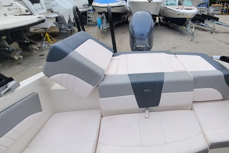 Slide: The Image of 2020 Chaparral 21 SSi OB boat interior with cushioned seating and Yamaha 200 outboard motor. - 17