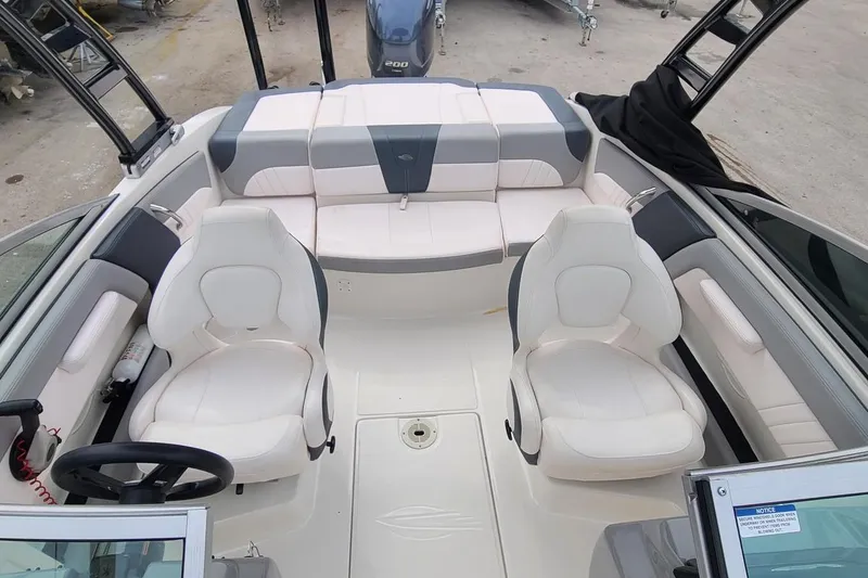 Slide: The Image of 2020 Chaparral 21 SSi OB boat interior with white seating and steering wheel. - 19