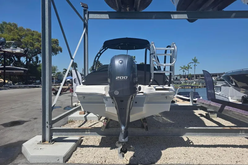 Slide: The Image of 2020 Chaparral 21 SSi OB boat with Yamaha 200 engine on display at marina. - 2