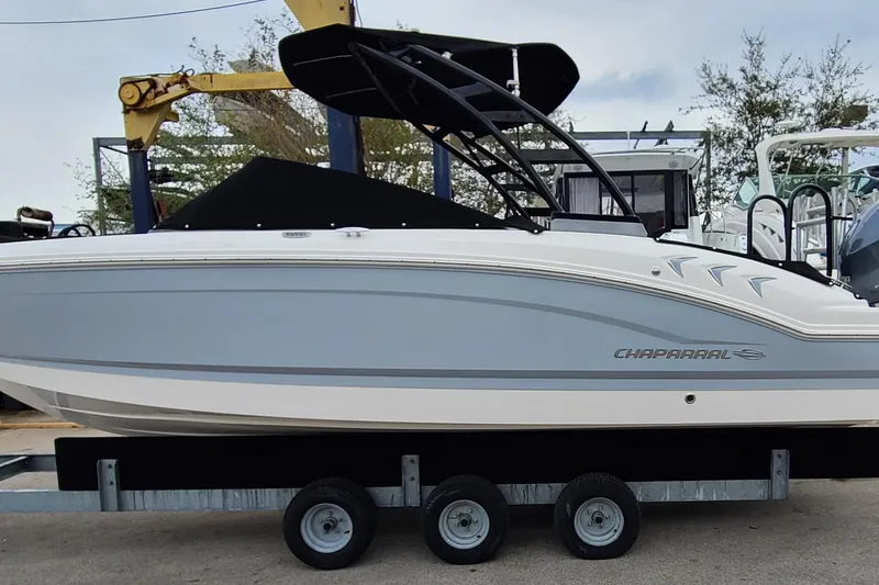 Slide: The Image of 2020 Chaparral 21 SSi OB boat on trailer, featuring sleek design and modern aesthetics. - 22