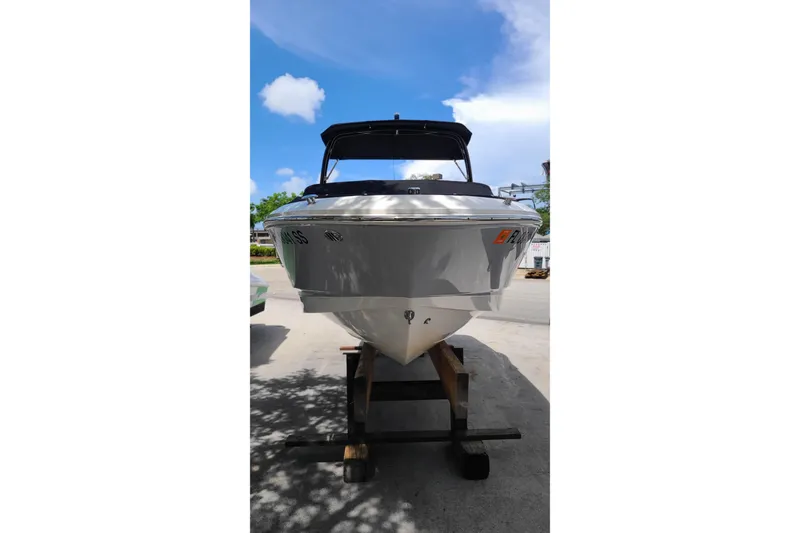 Slide: The Image of 2020 Chaparral 21 SSi OB boat on a stand under a clear blue sky. - 5