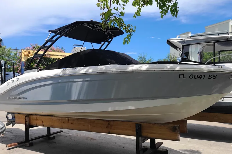 Slide: The Image of 2020 Chaparral 21 SSi OB boat on display, featuring sleek design and black canopy. - 6