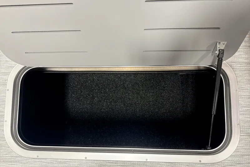 Slide: The Image of Open storage compartment in 2026 Bennington 22 S Quad Bench boat. - 10
