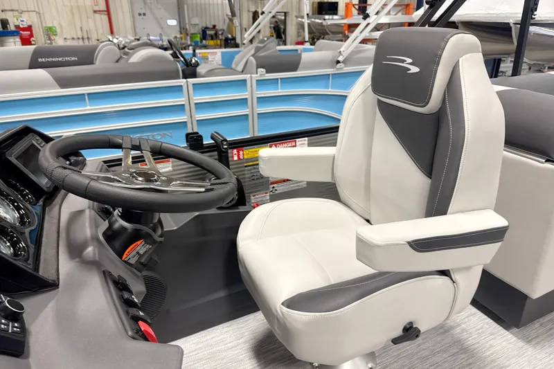 Slide: The Image of Captain's chair and steering wheel of 2026 Bennington 22 S Quad Bench pontoon boat. - 8