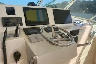 Slide: The Image of 2008 Albemarle 360 Express Fisherman boat interior with cushioned seating and ocean view. - 17