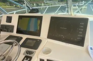 Slide: The Image of 2008 Albemarle 360 Express Fisherman dashboard with navigation screens and controls. - 22