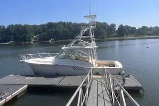 Slide: The Image of 2008 Albemarle 360 Express Fisherman docked on a serene lake under a clear blue sky. - 3