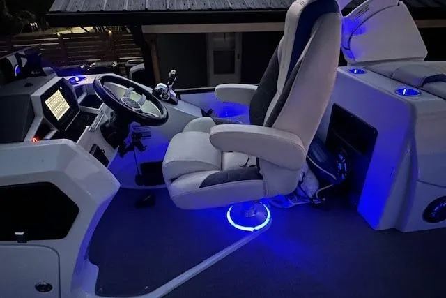 Slide: The Image of Captain's chair with blue LED lighting on 2020 Manitou 25 X-Plode RFW boat. - 4
