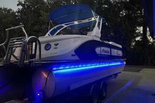 Slide: The Image of 2020 Manitou 25 X-Plode RFW pontoon boat with blue LED lights and canopy. - 5
