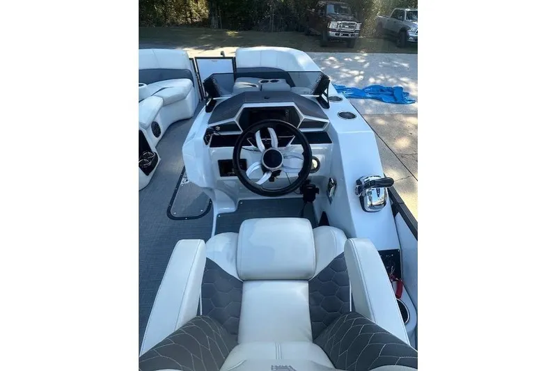 Slide: The Image of 2020 Manitou 25 X-Plode RFW boat interior with modern steering and seating. - 8