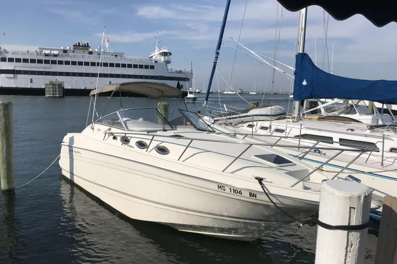 The Image of 2001 Regal Commodore 2660 boat docked in marina with ferry in background. - 0
