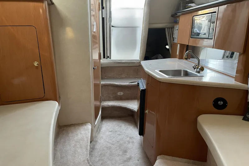 Slide: The Image of Interior of 2001 Regal Commodore 2660 boat with kitchenette and stairs. - 17