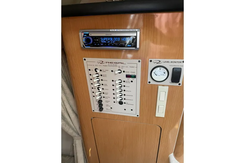 Slide: The Image of Control panel of a 2001 Regal Commodore 2660 boat with stereo and level monitor. - 18