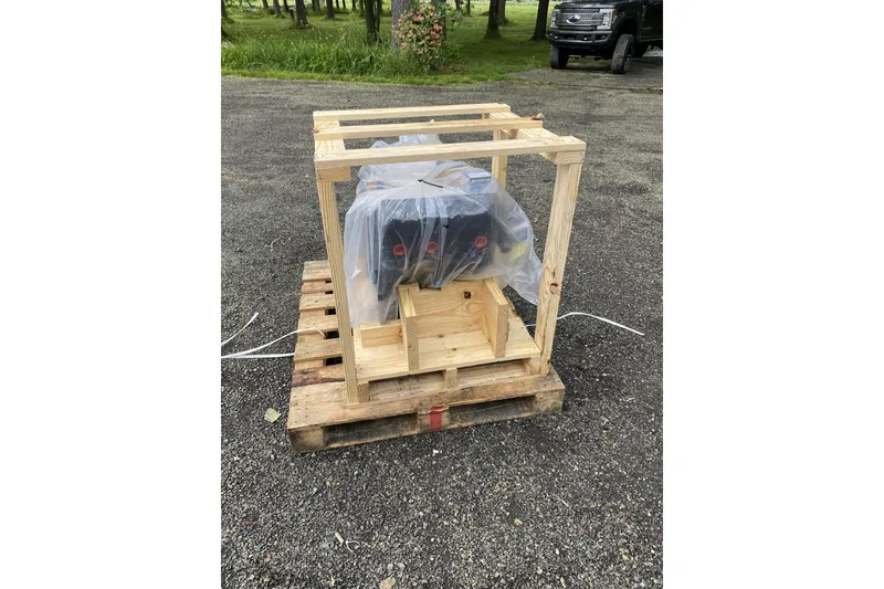 Slide: The Image of Wooden crate on pallet containing engine for 2001 Regal Commodore 2660, wrapped in plastic. - 19