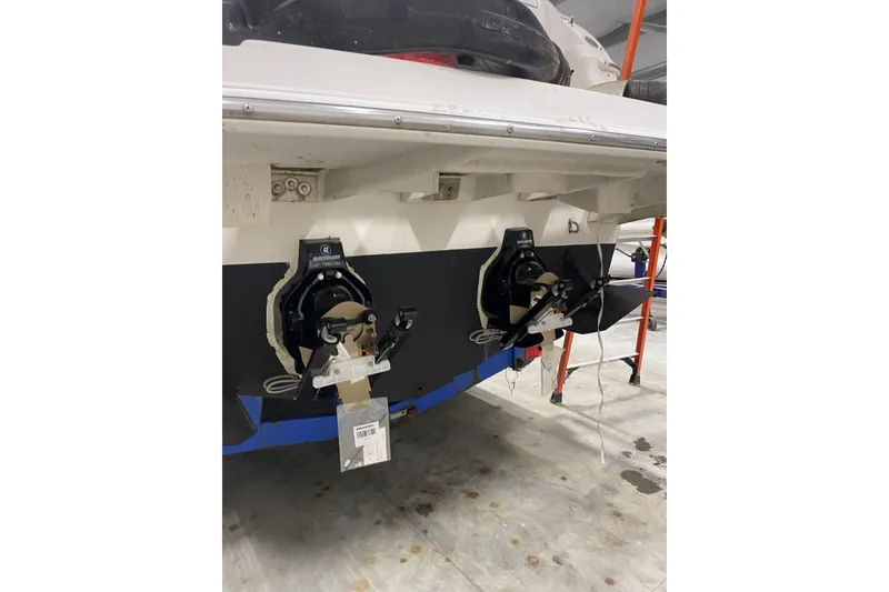 Slide: The Image of Rear view of a 2001 Regal Commodore 2660 boat in a garage setting. - 20