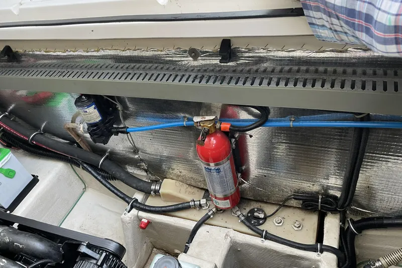 Slide: The Image of Engine compartment of a 2001 Regal Commodore 2660 boat with fire extinguisher and wiring. - 23