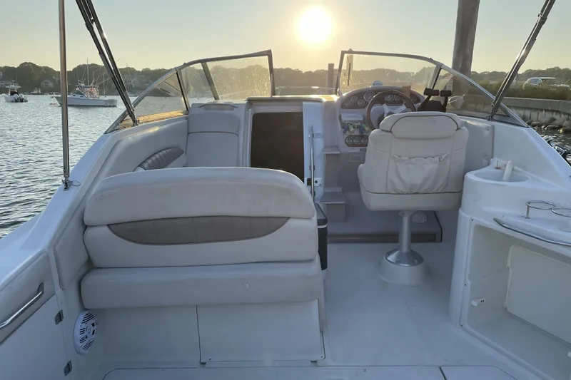 Slide: The Image of 2001 Regal Commodore 2660 boat interior at sunset, featuring helm and seating area. - 3