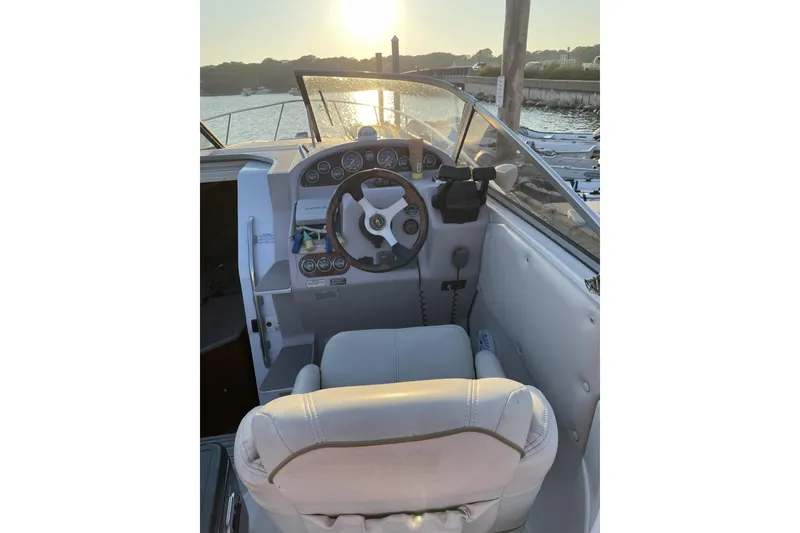 Slide: The Image of 2001 Regal Commodore 2660 boat cockpit with steering wheel at sunset. - 4