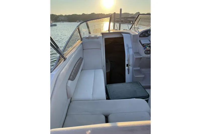 Slide: The Image of 2001 Regal Commodore 2660 boat interior with seating, sunset view over water. - 5