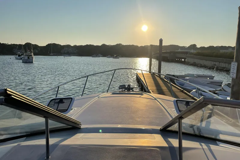 Slide: The Image of 2001 Regal Commodore 2660 boat docked at sunset, serene waterfront view. - 7