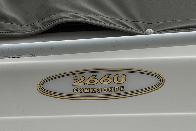 Slide: The Image of 2001 Regal Commodore 2660 boat emblem with gold lettering on a white background. - 9