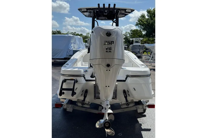 Slide: The Image of Steering console of 2026 BlackJack 256 Coastal boat with modern controls and cup holders. - 10