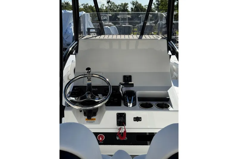 Slide: The Image of Storage compartment on a 2026 BlackJack 256 Coastal boat with tackle boxes. - 14